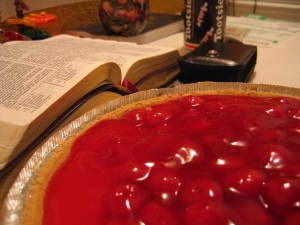 Photo of the  scriptures with a cherry pie.