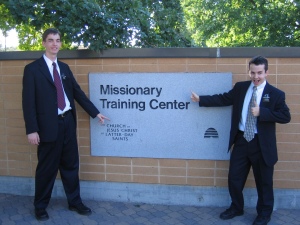 Photo of Elders Willoughby and Campbell by the MTC sign