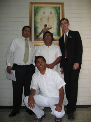 Photo with four men, one ready to be baptized.