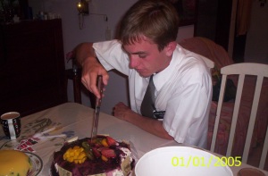 Photo of Elder Willoughby cutting his birthday cake