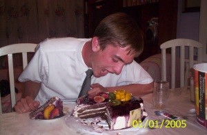 Photo of Elder Willoughby pretending to eat the whole cake