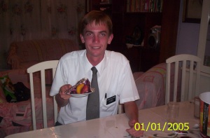 Photo of Elder Willoughby with a slice of cake looking very happy