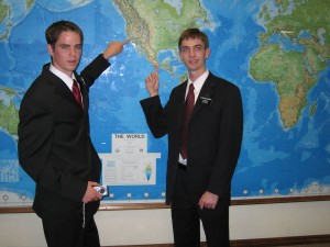 Two elders pointing to mission destinations on MTC map