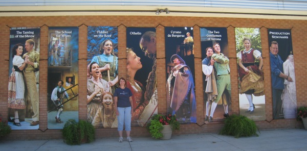 Jill by the posters of all the plays.