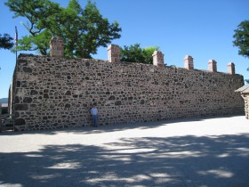 Jill by the north wall of Cove Fort