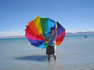 Derek had to run after the beach umbrella when a breeze blew it into the lake.