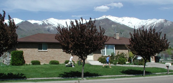 Jake pursues Daniel across the lawn for non-payment of property taxes.