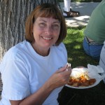 Jill enjoys her food in the shade