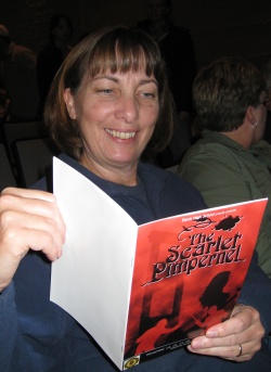 Jill holding a program.