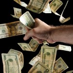 Hand grabbing at twenty dollar bills Photo credit: Steve Wampler
