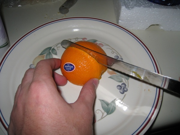 Turn the orange on its face to cut in two