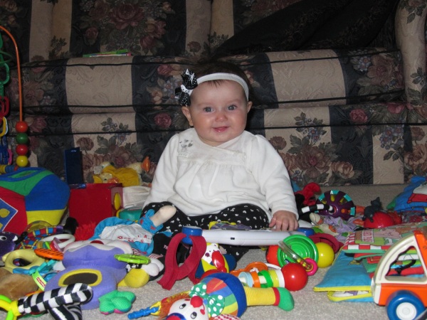 Aurora checks out the toys that surround her.