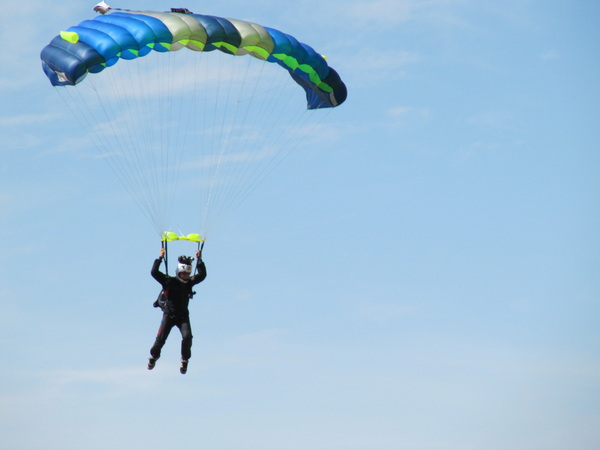 Skydiving photographer comes in first to land.