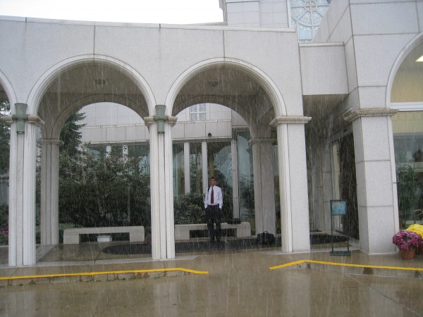 My son Jake sheltering from the rain under the temple porch