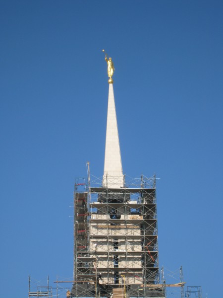The temple is topped with the traditional gold-leafed angel Moroni statue