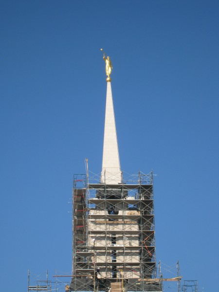 The temple is topped with the traditional gold-leafed angel Moroni statue