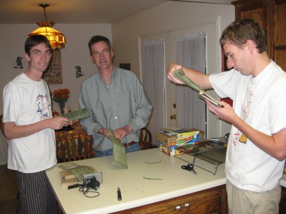 Jake, Rick, and Paul slip the food pouches into the supplied heaters.