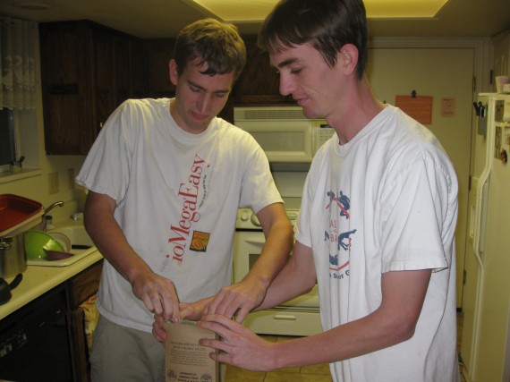 Paul and Jake put the heater and the food pouch back in the box. 
