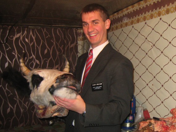 Daniel holding a cows head in Mongolia