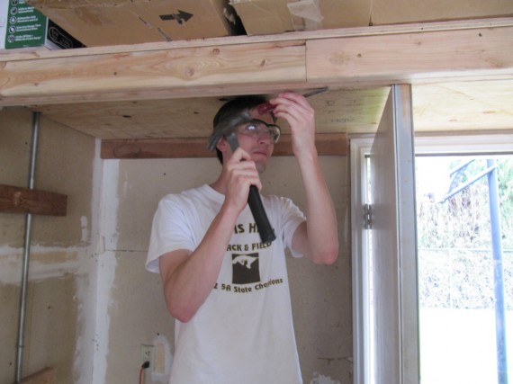 Jake cuts away some of the beam so the door will open