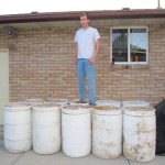 Paul standing on ten barrels