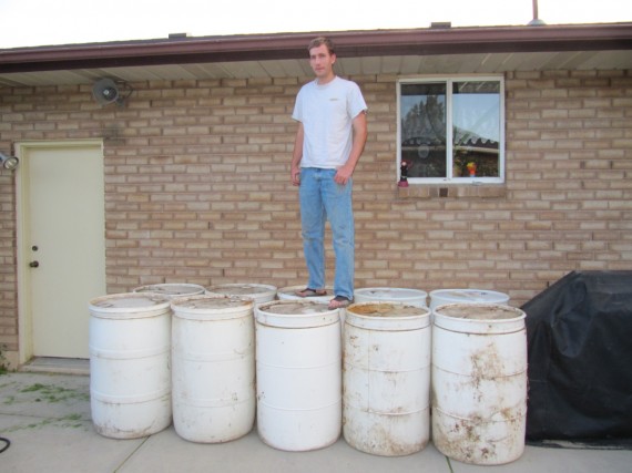 Paul standing on ten barrels