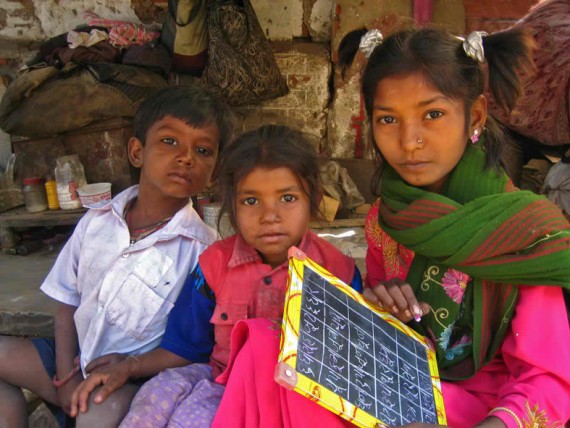 Children doing homework in Manek Chowk slum