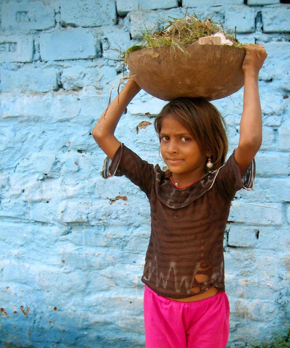 Girl clearing rubble at Kochrab, India