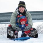 Sarah, Bryson, and Aurora ready to sled
