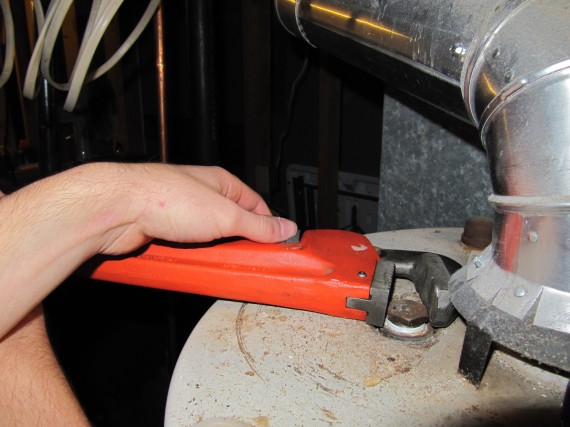 Using a wrench to remove the anode